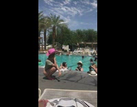 Girl pink hat sit no pants poolside