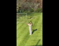 Girl white pants take selfie yard sunny 