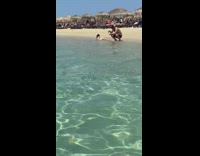 Woman black bikini lie down sideways beach