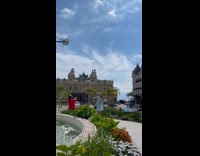 Collab IITW - Woman in blue floral dress poses and spins at the park