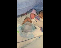 Newborn baby give its mother a kiss