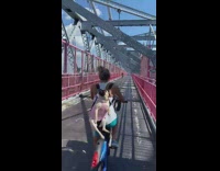 Woman on bike pug on backpack behind her