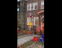 Collab WINY - Giant skeleton outside house with christmas decorations