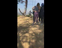 crowds around swing on hill