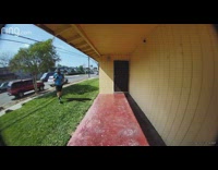 Delivery driver kicks package towards front door 