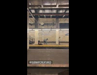six people dressed up perform on empty subway station