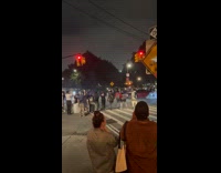 Crowd watch car drift around the intersection
