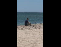 Man blue shirt fix hair selfie monopod beach