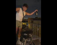 Champagne bottle explodes guy holds over balcony