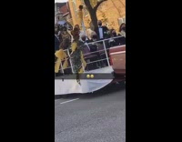 Brown truck tows platform pope guy waves 