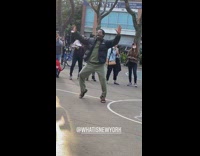 Black jacket green pants guy dances court 