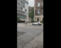Guy skates along the road in NY at day alone with vehicles