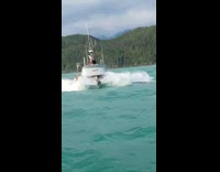 Fishing boat crashing and riding the rough waves in southeast Alaska