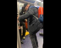 Old man dance while band performs inside train