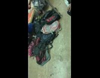 Guy blue shorts brings a lot of backpacks onto subway train and leaves them on the floor