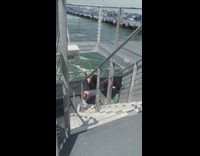 Woman Squats on Boat for Photo