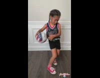 Young girl shows off basketball tricks