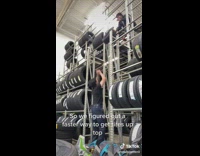 Guy throws tires to top shelf