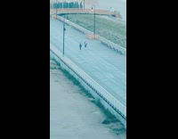 Two guys music video closed beach walkway 