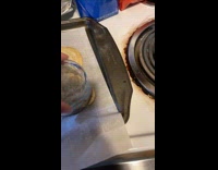 Girl uses glass cup to shape cookie 