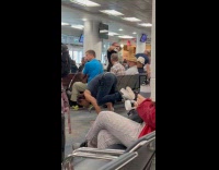 Man handstand at the airport lobby aisle