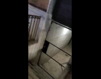 Red shirt lady hula hoops inside laundromat 