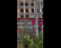 Woman in black leather suit in a superhero stance