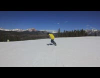 Guy on snowboard spins and flips mountain 