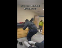 Guy standing at door making friends laugh 