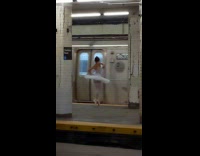 Ballerina dances and spins around subway platform 