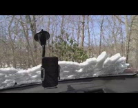 Blocks of snow slide down car windshield 