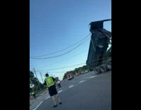 Dump truck back stuck on the electric lines