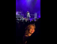 Woman selfie video with flash at concert