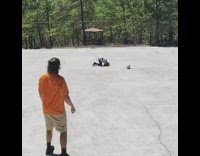 man orange throws ball kid striped shirt