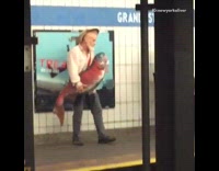 Man with straw hat hold big giant red fake fish and sings in subway station