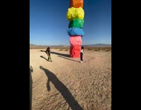 Woman black top photo shoot colorful stacked stones