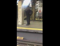 Man practices boxing punch on metal pillar on subway station