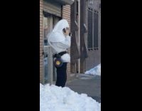 Person wears white ventilated hood mask phone