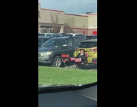Guy taking nap on two lawn chairs behind parked car