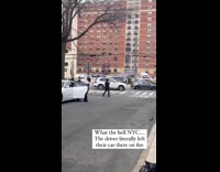 Black car on fire is left on the street 