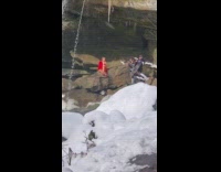 Woman red dress snowy waterfalls three photographers