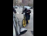 Man with scream mask displayed on bike