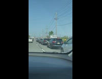 Two guys hold onto uhaul while it drives