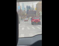 Guy runs in the middle of the street with cars