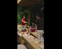 Two guys swing flyswatter friend belly slap