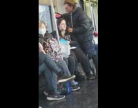 Man brushes his wife hair on the train 