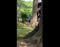 Man blue shirt touch tree both hands