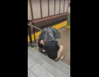 Subway couple hides under umbrella 