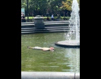 Random guy takes dip in public fountain