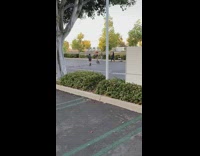 Two women bell bottoms video shoot parking lot